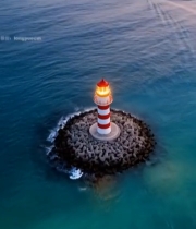  海上灯塔与行驶小船俯瞰画面6144#竖屏 	 